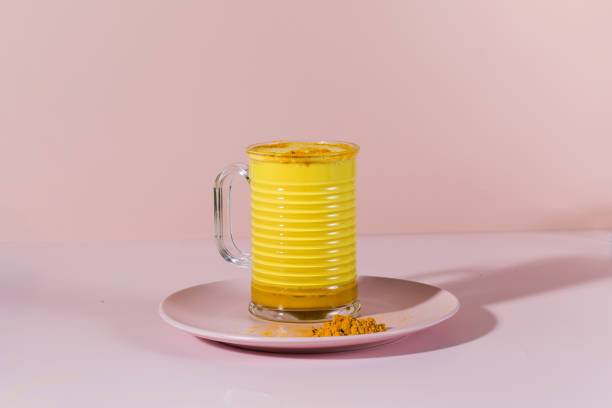 istock Latte turmeric on a pink background with hard shadows. Moon milk for better sleep. Copy space. 1353565523