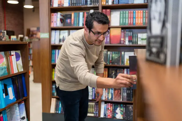 Man Choosing a Book in the Library