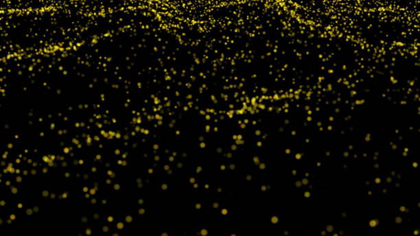 istock golden glitter explosion. Dust particle isolated on black background 1353568937