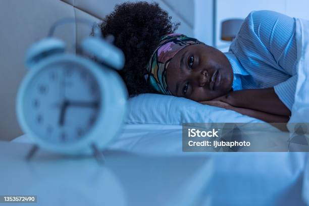 Depressed Young Woman Lying In Bed And Feeeling Upset After Quarrel With Her Boylfriend In Bed At Home Stock Photo - Download Image Now