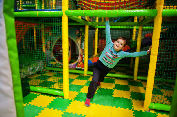 istock Cute boy playing in indoor play center. 1353572512