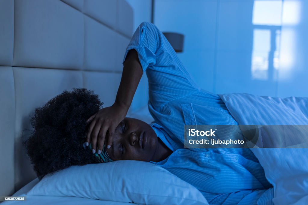 Sad woman suffering  while layin in bed at night Sleeping Stock Photo