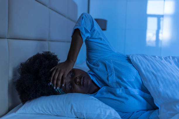 Sad woman suffering  while layin in bed at night Sad woman suffering  while layin in bed at night trouble sleeping stock pictures, royalty-free photos & images