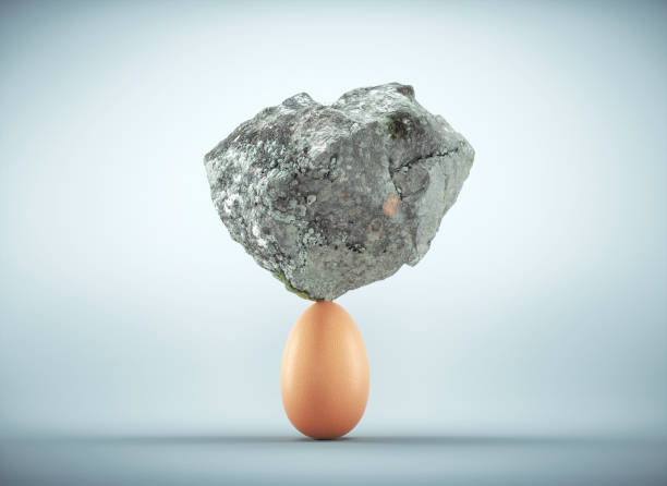 rock standing on egg.  unstoppable and strong idea concept. this is a 3d render illustration - possible imagens e fotografias de stock