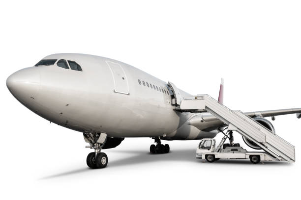 istock Wide body passenger airplane with boarding ramp isolated on white background 1353572929