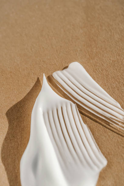 istock The texture of the white cream on a beige background. 1353573003