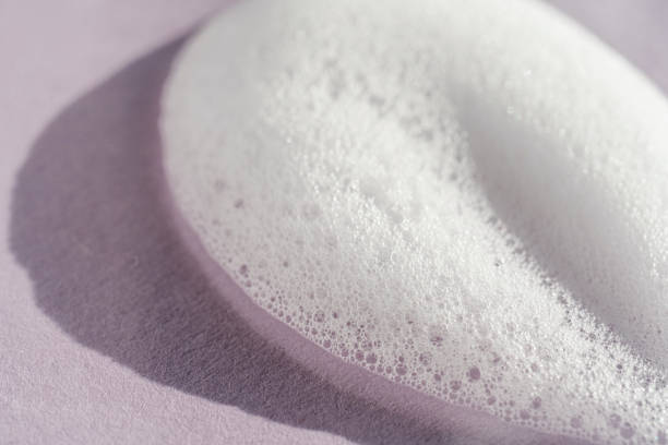istock Texture of white foam on a purple background. 1353573007