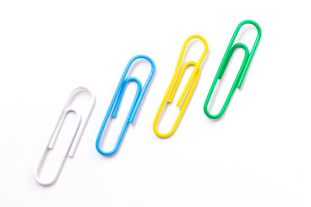 istock Colorful plastic paper clipson on a white background 1353574457