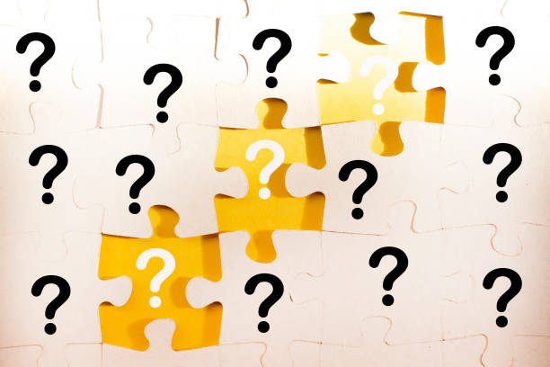 istock question marks and white jigsaw puzzle pieces on a yellow background. FAQ, Business solution concept 1353574466