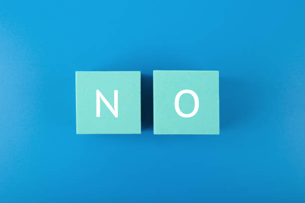 istock Say no or negative answer minimal concept on blue background. No written on toy cubes 1353574579