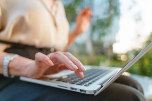 istock A close up of a woman's hand going to press the button on a laptop 1353576149