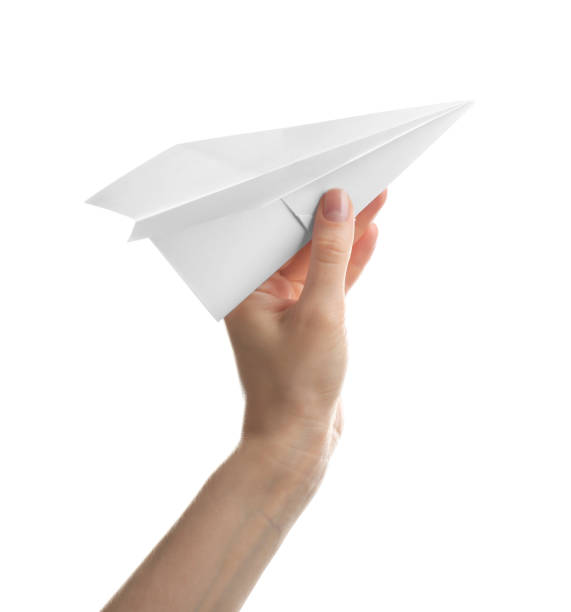 istock Woman holding paper plane on white background, closeup 1353576876
