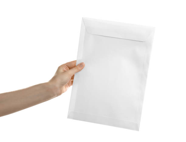 istock Woman holding paper envelope on white background, closeup 1353577143