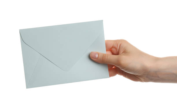 istock Woman holding paper envelope on white background, closeup 1353577269