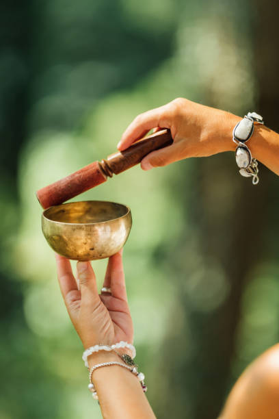 istock Woman Playing on Tibetan Singing Bowl 1353577781