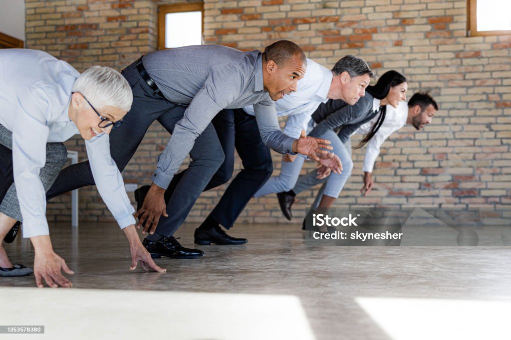 Sports race in the office! Large group of business people starting a race in the office. Copy space. Running Stock Photo