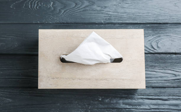 istock Box of tissues on grey wooden table, top view 1353578622