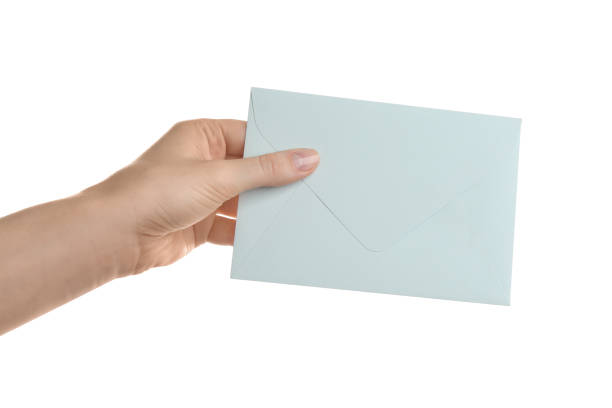 istock Woman holding paper envelope on white background, closeup 1353579118