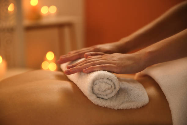 young woman receiving hot towel massage in spa salon, closeup - beautician body care relaxation luxury imagens e fotografias de stock