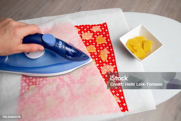 Close Up View Of Person Woman Make Beeswax Wraps For Wrapping Food In Home Indoors Alternative For Plastic Use Iron Machine To Melt Beeswax Into Cotton Cloth Stock Photo - Download Image Now