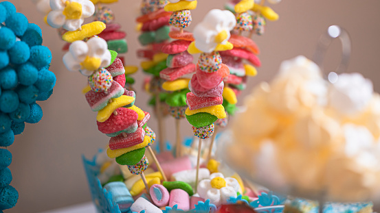 Image with variety of sweets stacked on a festive table.