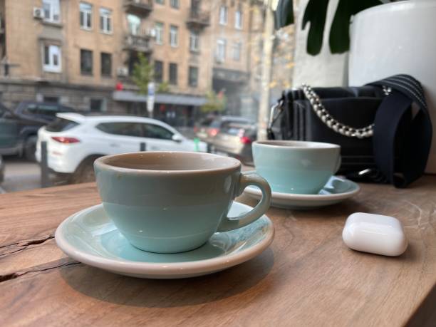 istock Two cups of coffee on the table near window 1353580427