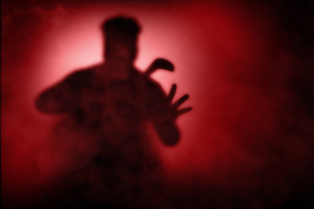 istock Silhouette of a scary zombie holding sickle 1353580969
