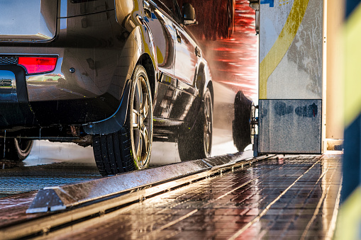 Cleaning of car in automatic car wash.