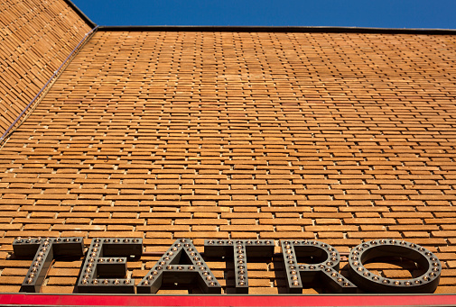 Brick wall with Italian word for theatre.