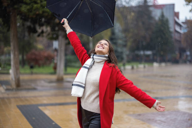 istock Young woman enjoying rainy weather 1353586028