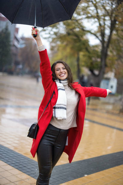 istock Young woman enjoying rainy weather 1353586029