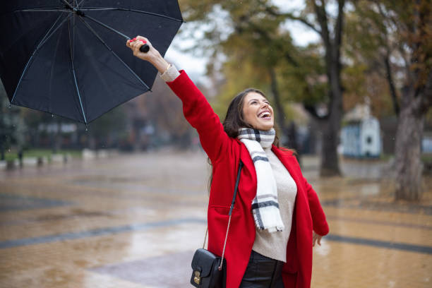 istock Young woman enjoying rainy weather 1353586030