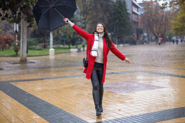 istock Young woman enjoying rainy weather 1353586039