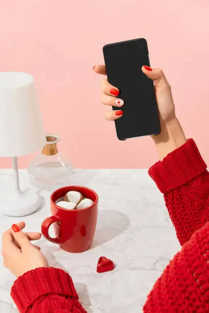 Photo of Well-groomed female hands on marble table. Trendy fashion accessories