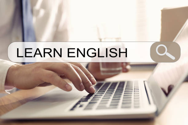 istock Search bar of internet browser with text Learn English and man using laptop in office, closeup 1353592034