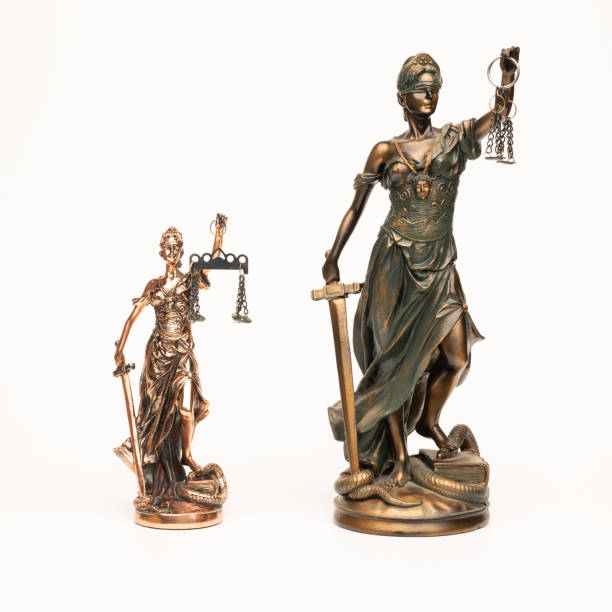 istock Justilia or Themis (Symbol of Justice) statue isolated on white background with clipping path 1353592103