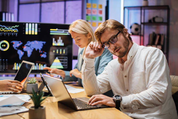 istock Partners working on financial report with gadgets at office 1353592200