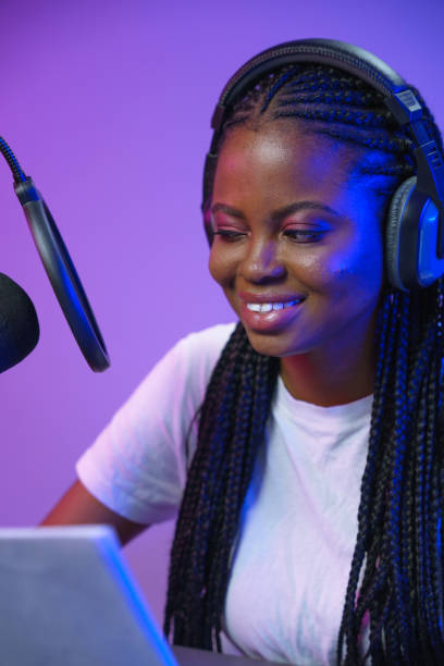 istock A close up of a smiling dark skinned radio DJ with the script in her hands 1353592885