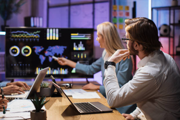 istock Diverse partners examining financial statistics on monitor 1353593301