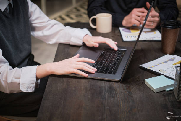 istock Businesswoman using laptop at meeting 1353593654