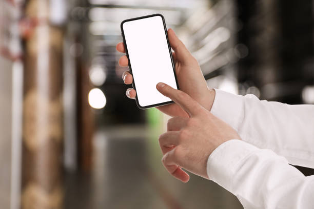istock Wholesale trading. Man using WMS app on smartphone at warehouse, closeup 1353593668