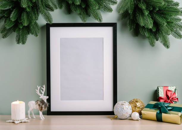 istock Christmas composition of Christmas decorations, pine branches, candle, deer and mock up poster frame for presentation of works and text. Template. 1353593708
