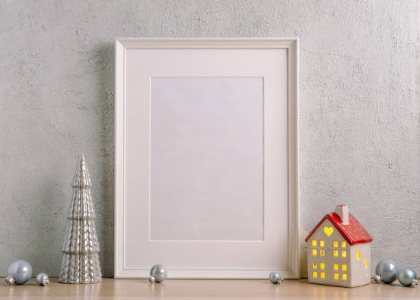 istock Christmas composition of Christmas decorations, pine branches, House lantern and a white mock up poster frame for presentation of works and text. Template. 1353593993