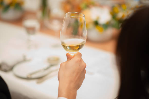 istock guest hold wine glass in fine dining restaurant 1353594942