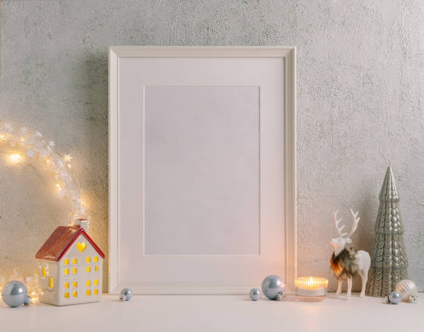 istock Christmas composition of Christmas decorations, pine branches, House lantern and a white mock up poster frame for presentation of works and text. Template. 1353594980