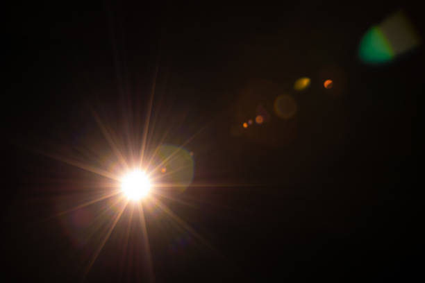 istock Sun flare on the black background 1353596077