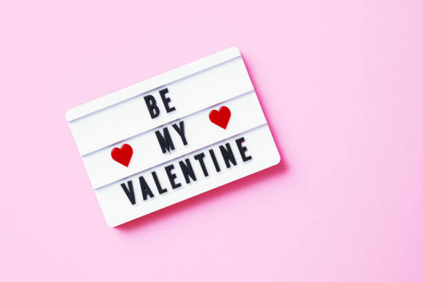 istock Be My Valentine Written White Lightbox Sitting On Pink Background 1353596450