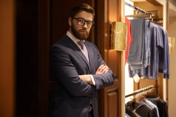 istock Concentrated young bearded businessman standing indoors 1353598817
