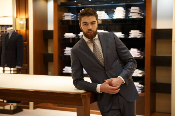 istock Man in suit standing near the table  shop 1353600327
