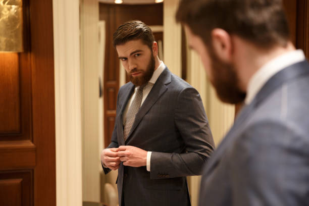 istock View from back of handsome  man looking at the mirror 1353600401